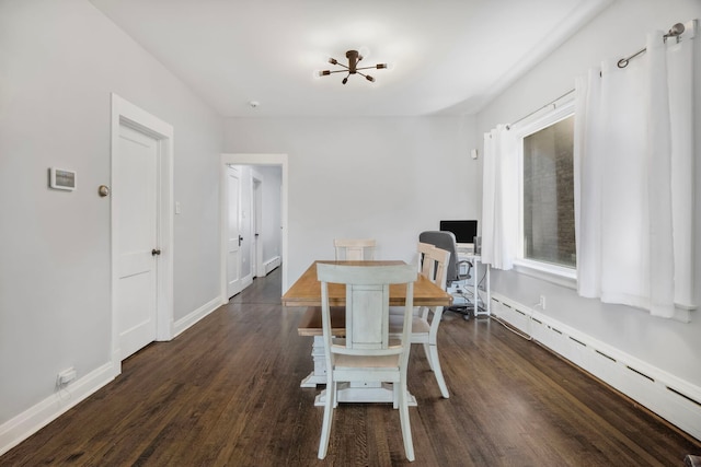 dining space with a baseboard radiator, dark wood-style flooring, and baseboards