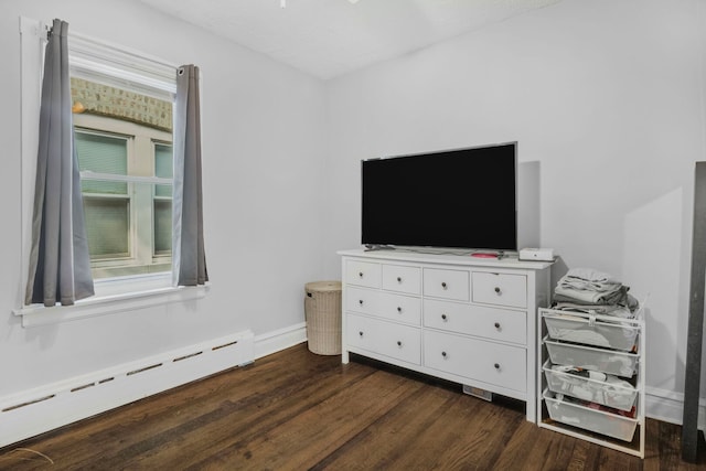 bedroom with baseboards, dark wood-style flooring, and baseboard heating