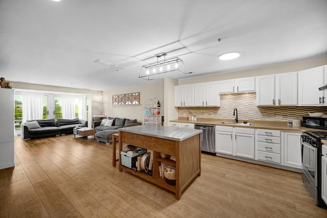 100 N Bokelman St Unit 430, Roselle, IL 60172 - kitchen featuring a sink, appliances with stainless steel finishes, light wood finished floors, white cabinets, and light countertops