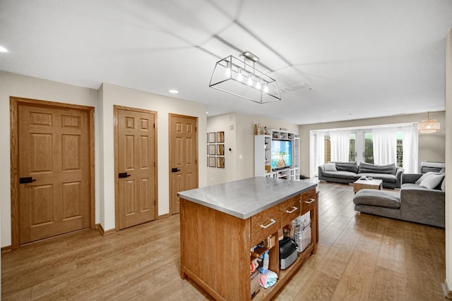 100 N Bokelman St Unit 430, Roselle, IL 60172 - kitchen featuring stainless steel countertops, light wood finished floors, a center island, recessed lighting, and open floor plan