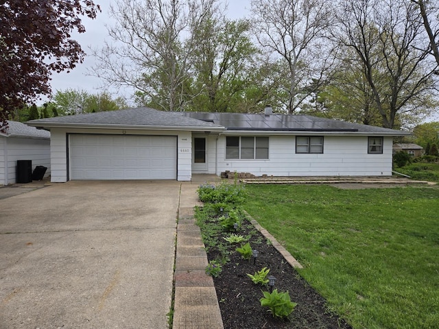 ranch-style house with concrete driveway, an attached garage, and a front yard