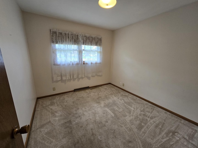 spare room featuring carpet, baseboards, and visible vents
