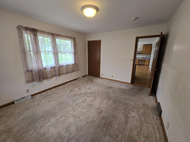 unfurnished bedroom with baseboards, a closet, visible vents, and carpet floors