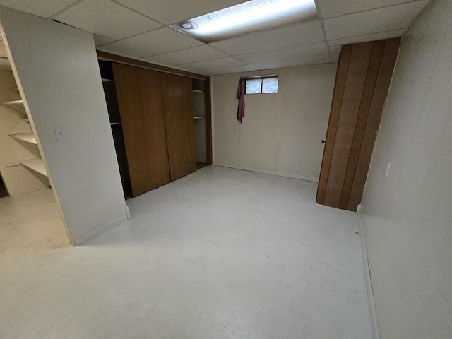 basement with a paneled ceiling