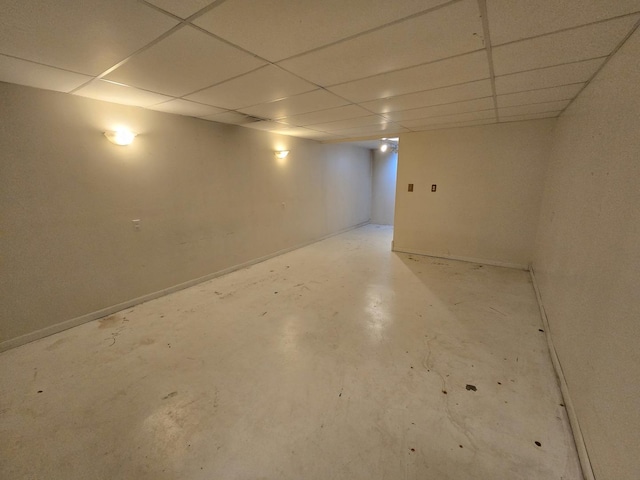 finished below grade area with baseboards and a drop ceiling