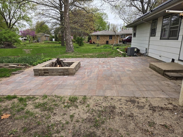 view of patio featuring central AC unit and an outdoor fire pit