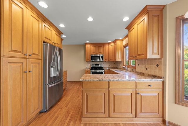 1624 Mirror Lake Dr, Naperville, IL 60563 - kitchen with stainless steel appliances, a sink, a peninsula, light stone countertops, and tasteful backsplash