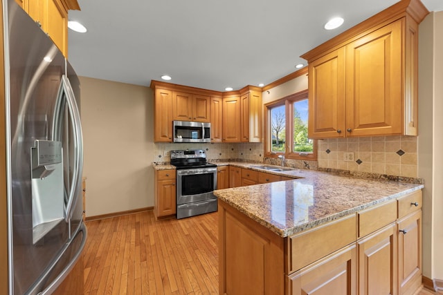 1624 Mirror Lake Dr, Naperville, IL 60563 - kitchen with stainless steel appliances, a peninsula, a sink, light wood-style flooring, and baseboards