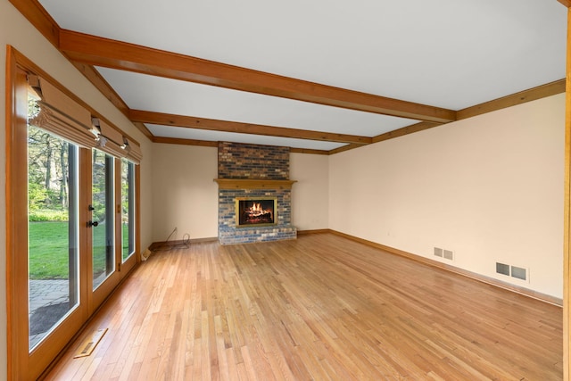 1624 Mirror Lake Dr, Naperville, IL 60563 - unfurnished living room with beam ceiling, light wood-type flooring, a brick fireplace, and baseboards