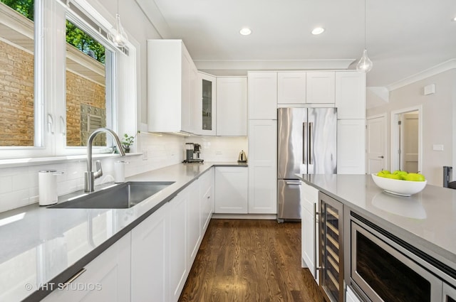 5263 N Laporte Ave, Chicago, IL 60630 - kitchen featuring stainless steel appliances, a sink, beverage cooler, dark wood-style flooring, and decorative backsplash