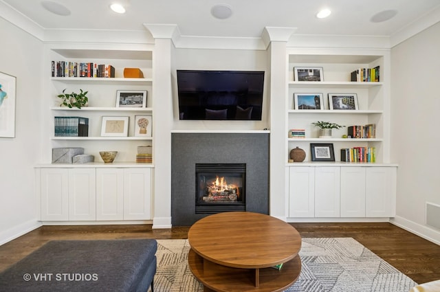 5263 N Laporte Ave, Chicago, IL 60630 - living room featuring dark wood-style flooring, a glass covered fireplace, built in shelves, crown molding, and baseboards
