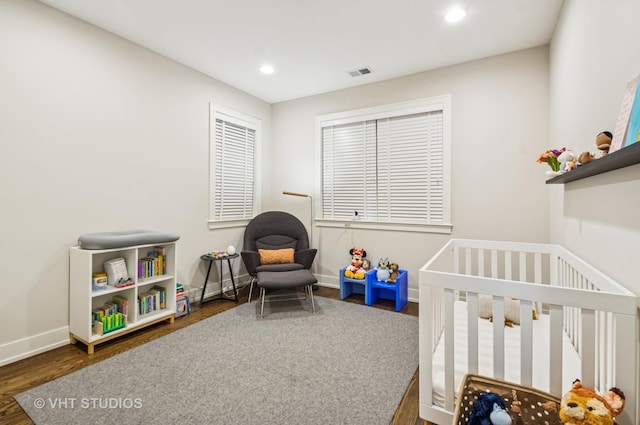 5263 N Laporte Ave, Chicago, IL 60630 - bedroom with wood finished floors, a nursery area, baseboards, and recessed lighting