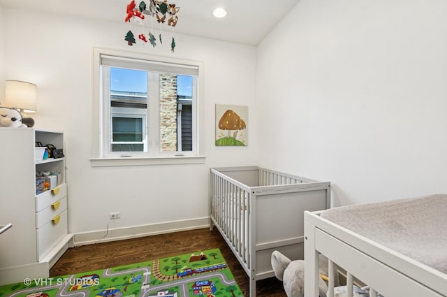 5263 N Laporte Ave, Chicago, IL 60630 - bedroom featuring dark wood finished floors, baseboards, and a crib