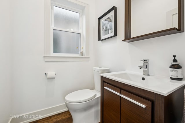 5263 N Laporte Ave, Chicago, IL 60630 - half bath featuring toilet, wood finished floors, vanity, and baseboards