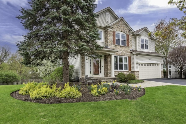 view of front of house featuring driveway, a garage, and stone siding