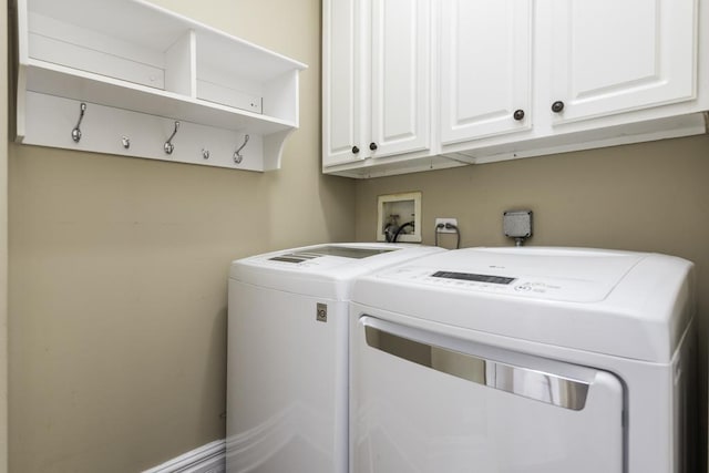 washroom with independent washer and dryer and cabinet space
