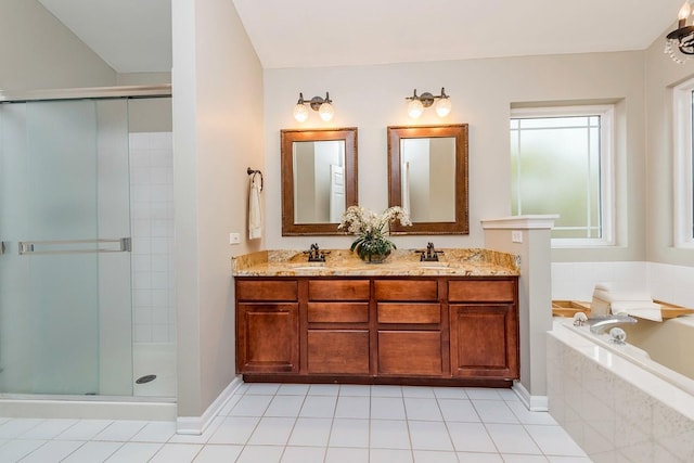bathroom featuring a stall shower, a garden tub, double vanity, and tile patterned floors