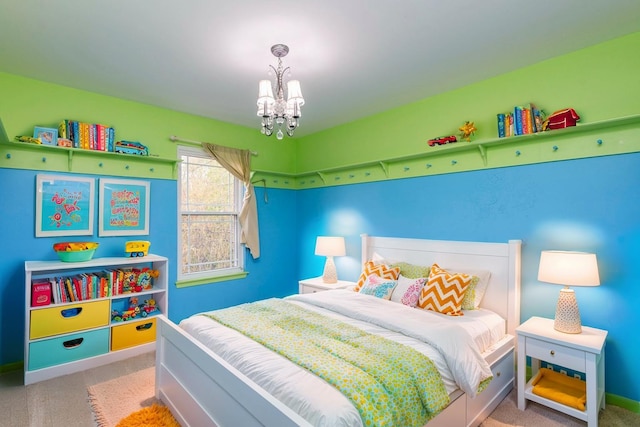 carpeted bedroom with a chandelier and baseboards