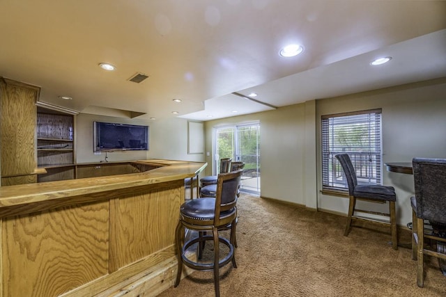 indoor bar featuring carpet floors, recessed lighting, and baseboards
