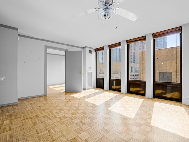 100 E Walton St Unit 18G, Chicago, IL 60611 - empty room featuring a ceiling fan, floor to ceiling windows, and baseboards