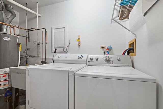 clothes washing area with separate washer and dryer and water heater