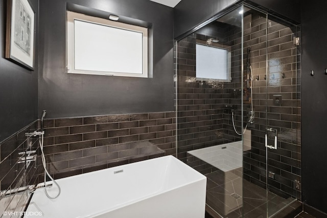 full bathroom with a freestanding bath and a stall shower