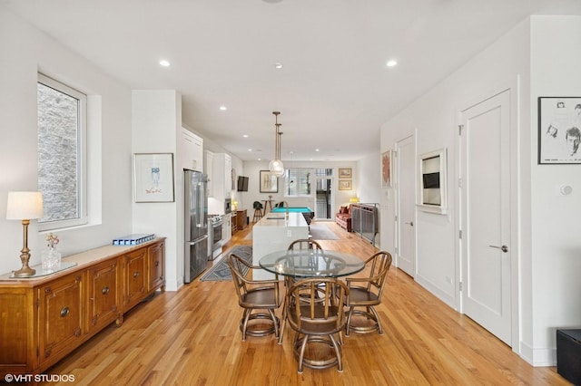 dining space featuring light wood-type flooring and recessed lighting