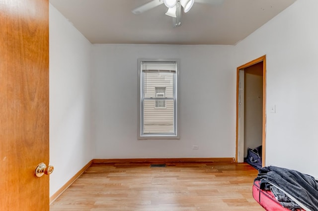 unfurnished room with a ceiling fan, baseboards, light wood-style flooring, and visible vents