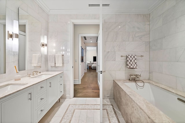 435 N Michigan Ave Unit 416, Chicago, IL 60611 - ensuite bathroom featuring crown molding, a garden tub, tile walls, and double vanity