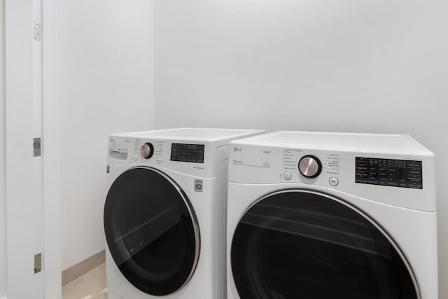435 N Michigan Ave Unit 416, Chicago, IL 60611 - laundry room featuring washing machine and dryer and light tile patterned flooring