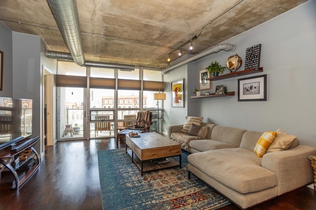 living area with wood finished floors and floor to ceiling windows
