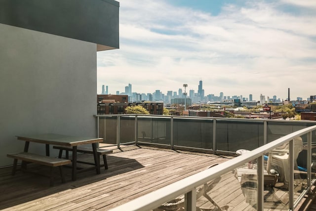 wooden deck featuring a view of skyline