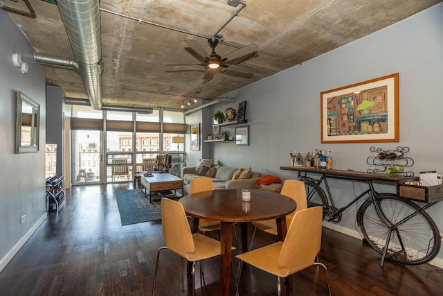 dining space with wood finished floors, a ceiling fan, and baseboards