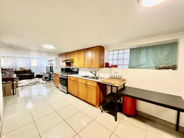 3328 S Oakley Ave, Chicago, IL 60608 - kitchen with a sink, brown cabinetry, gas range, light countertops, and light tile patterned flooring