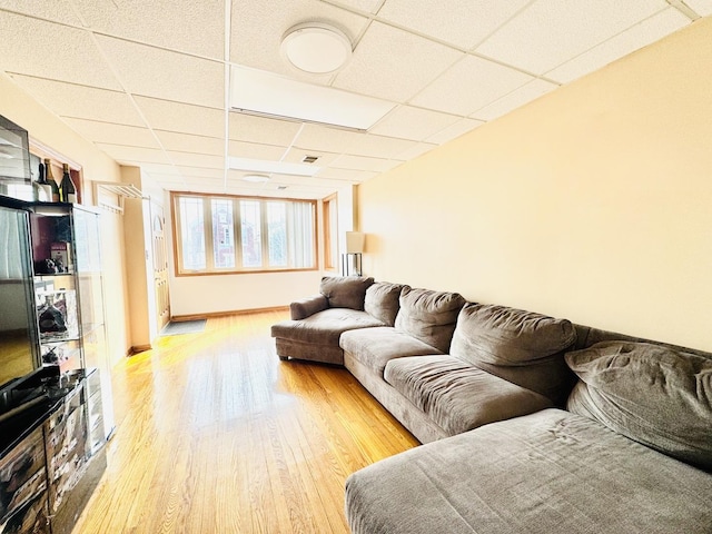 3328 S Oakley Ave, Chicago, IL 60608 - living room with a paneled ceiling, baseboards, and light wood-type flooring