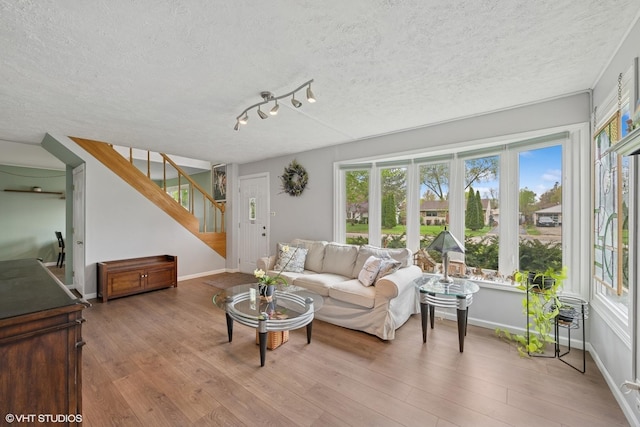 2404 Meadow Dr, Rolling Meadows, IL 60008 - living room featuring a textured ceiling, wood finished floors, plenty of natural light, and baseboards