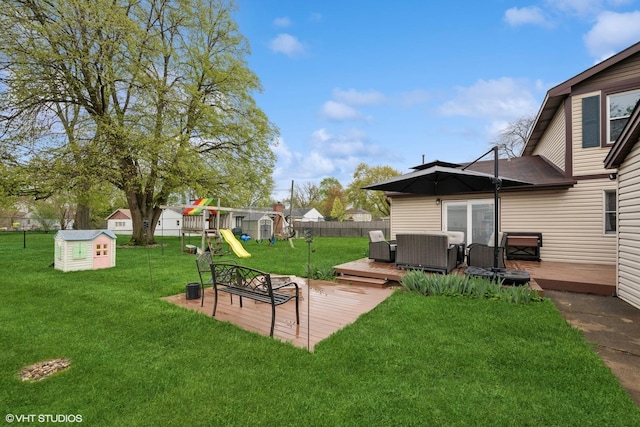 2404 Meadow Dr, Rolling Meadows, IL 60008 - view of yard featuring a deck, a storage unit, a playground, and an outbuilding
