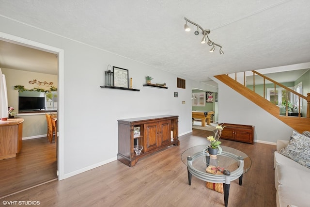 2404 Meadow Dr, Rolling Meadows, IL 60008 - living area with stairway, wood finished floors, pool table, a textured ceiling, and baseboards