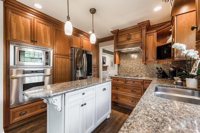 kitchen featuring appliances with stainless steel finishes, extractor fan, tasteful backsplash, brown cabinetry, and white cabinetry