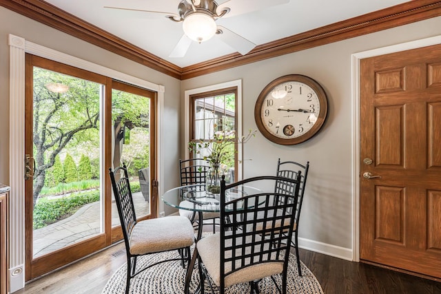 dining space featuring ceiling fan, baseboards, ornamental molding, and wood finished floors