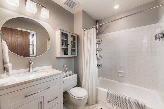 full bathroom featuring toilet, tile patterned floors, shower / bath combo, and vanity