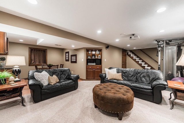 living room featuring carpet flooring, recessed lighting, and stairs