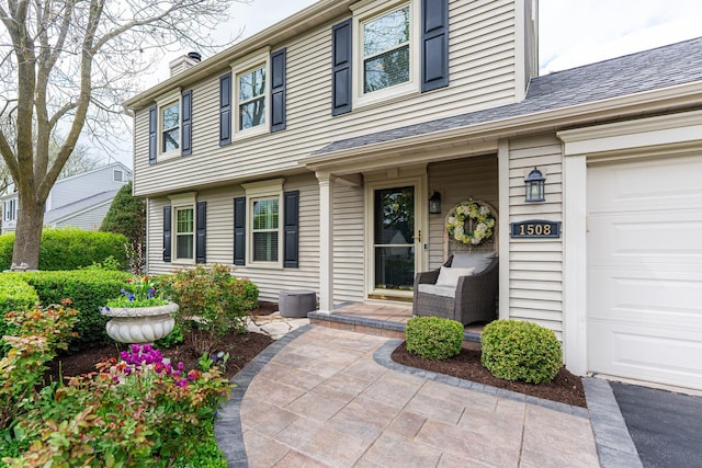 entrance to property with a porch and a chimney