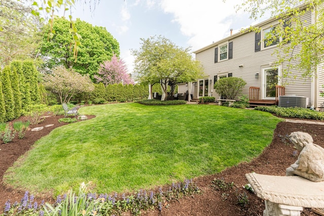 view of green lawn featuring central AC