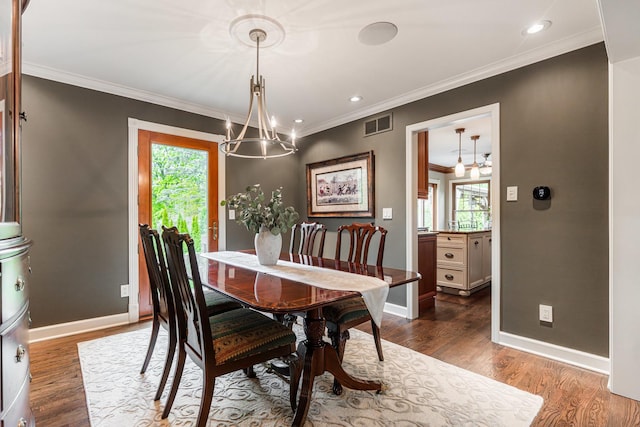 dining room with a chandelier, ornamental molding, baseboards, dark wood-type flooring, and recessed lighting