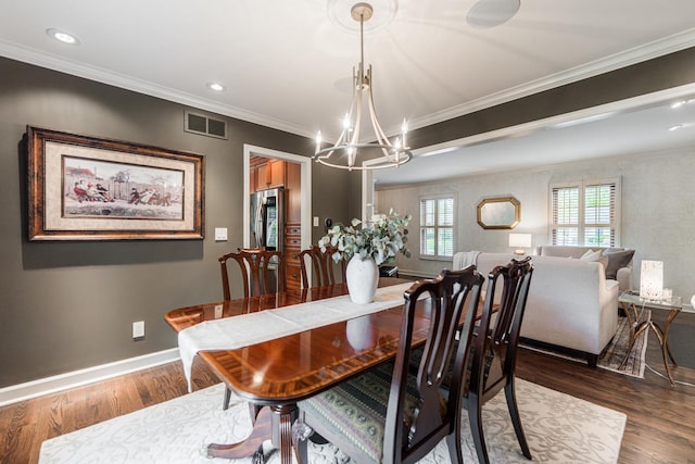 dining room featuring a chandelier, dark wood-style flooring, baseboards, crown molding, and recessed lighting