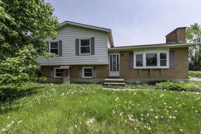 38815 N Pine Grove Ave, Wadsworth, IL 60083 - split level home with brick siding, a chimney, and entry steps