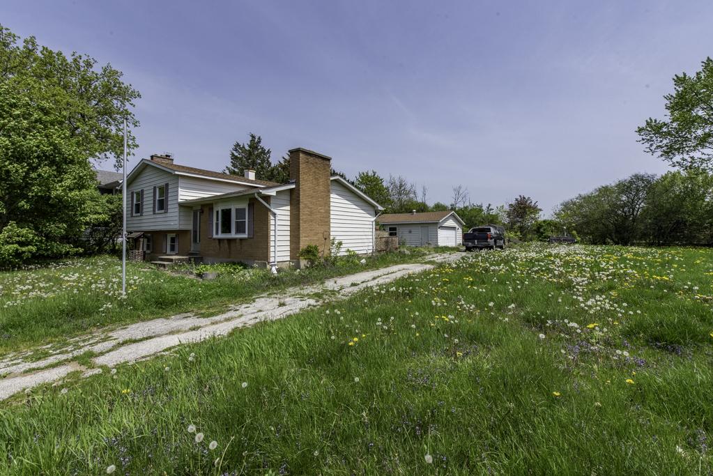 38815 N Pine Grove Ave, Wadsworth, IL 60083 - view of side of home with a chimney and a garage