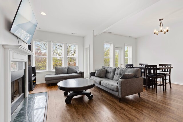6452 N Glenwood Ave Unit 3, Chicago, IL 60626 - living area featuring a premium fireplace, dark wood-style flooring, a chandelier, baseboards, and recessed lighting