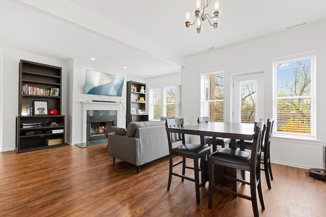 6452 N Glenwood Ave Unit 3, Chicago, IL 60626 - dining room with a chandelier, a premium fireplace, dark wood-type flooring, and built in shelves